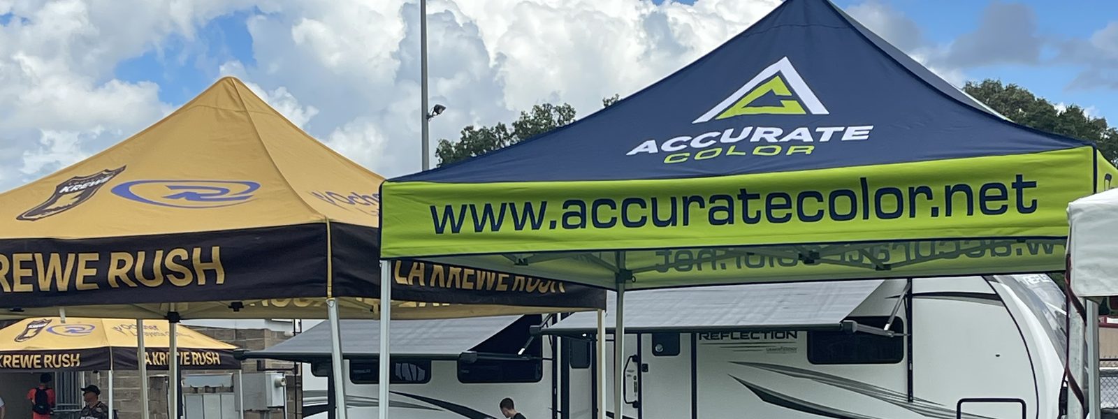 Accurate Color's own printed canopy tent set up beside a customer's tent at an outdoor event